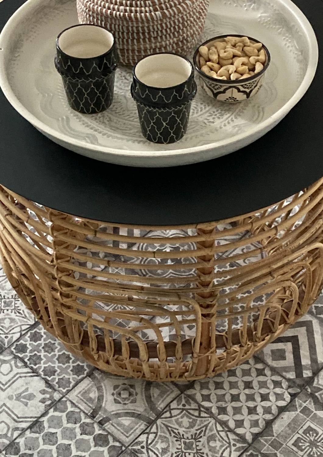 Rattan table with black metal cover